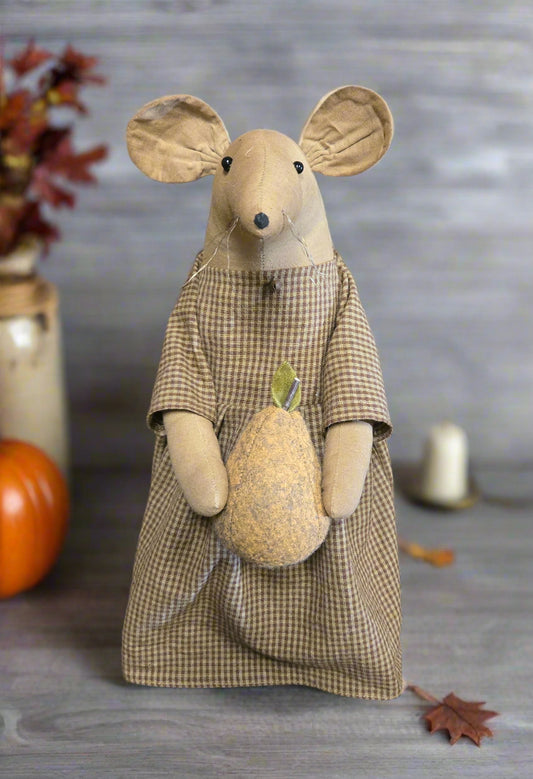 Stuffed mouse toy in a plaid dress holding a pear against a gray background with fall decor.