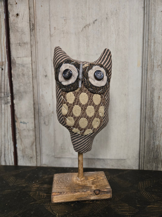 Wooden owl decoration on a wooden background