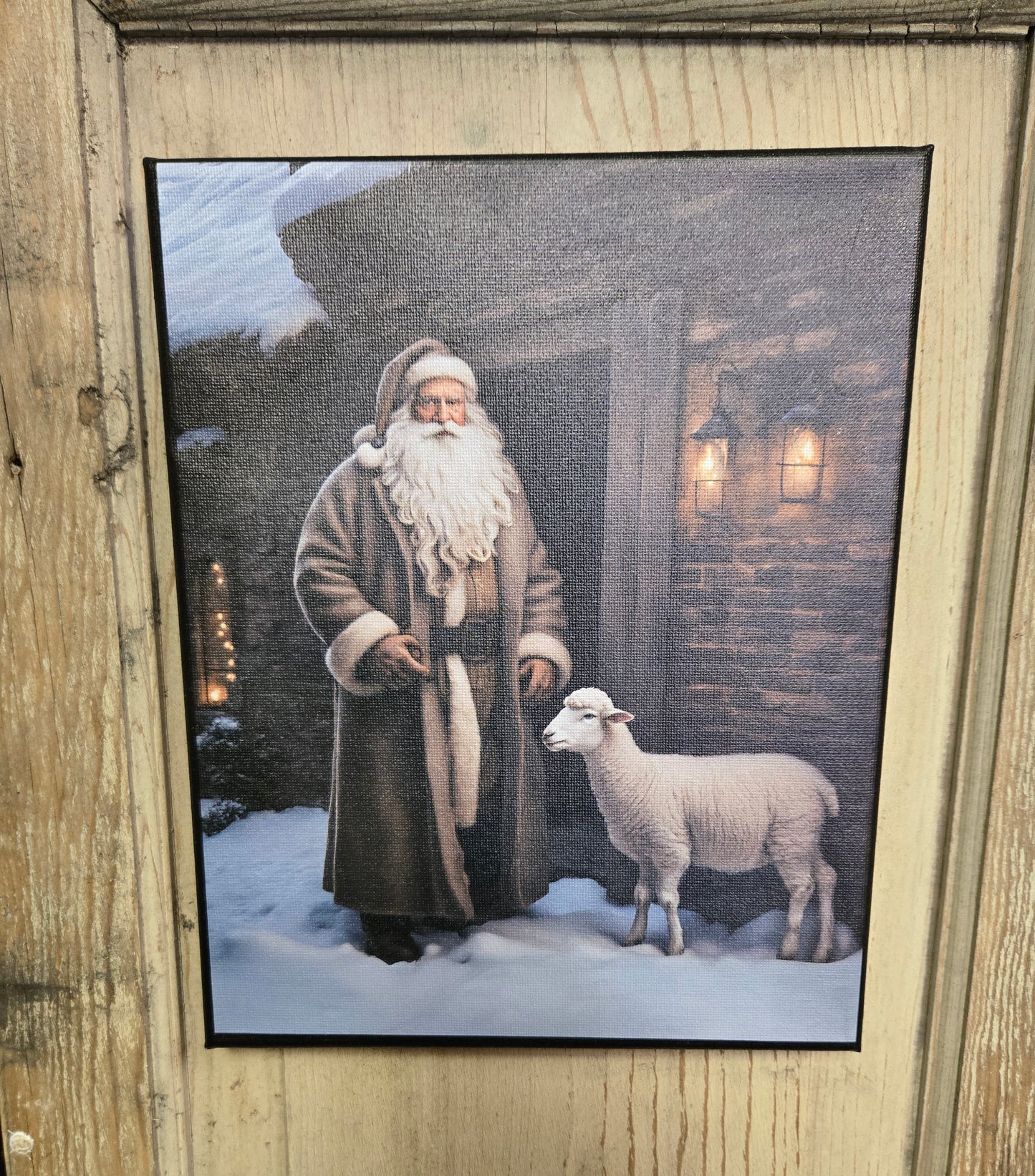 A canvas print featuring an illustration of Santa Claus with a sheep, set against a rustic wooden background.