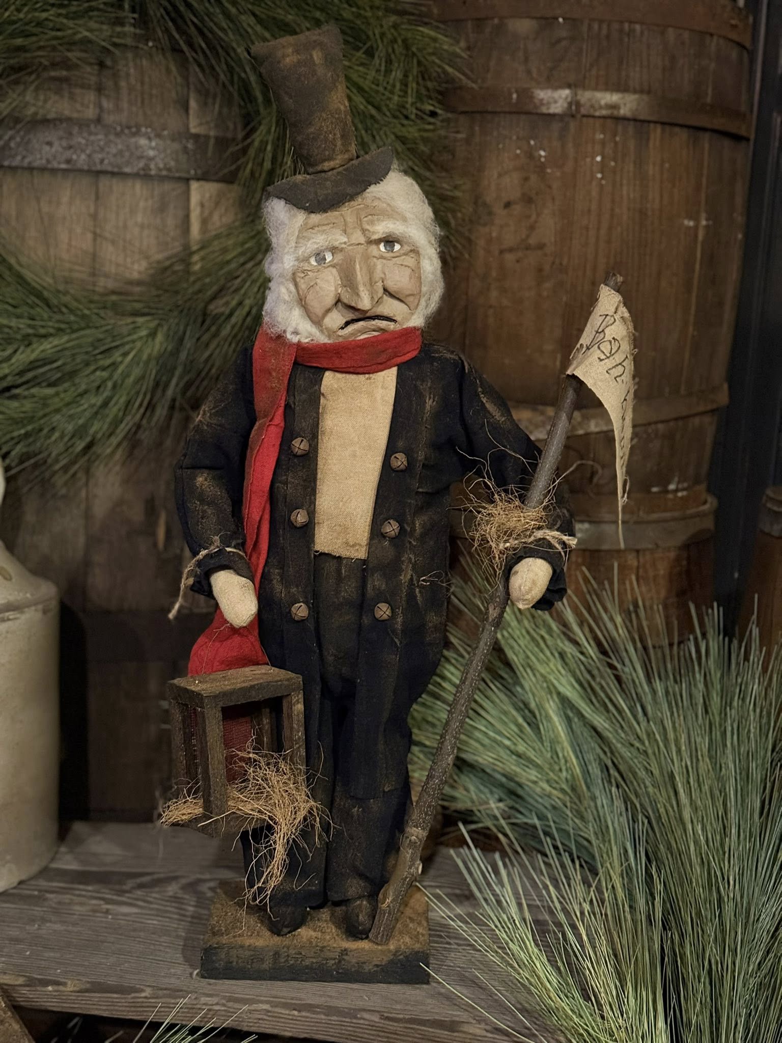 Vintage-style scrooge with a top hat and red scarf against a rustic background