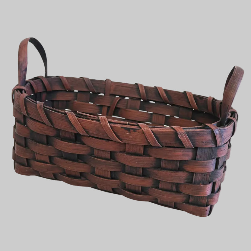 Burgundy woven basket on a wooden surface
