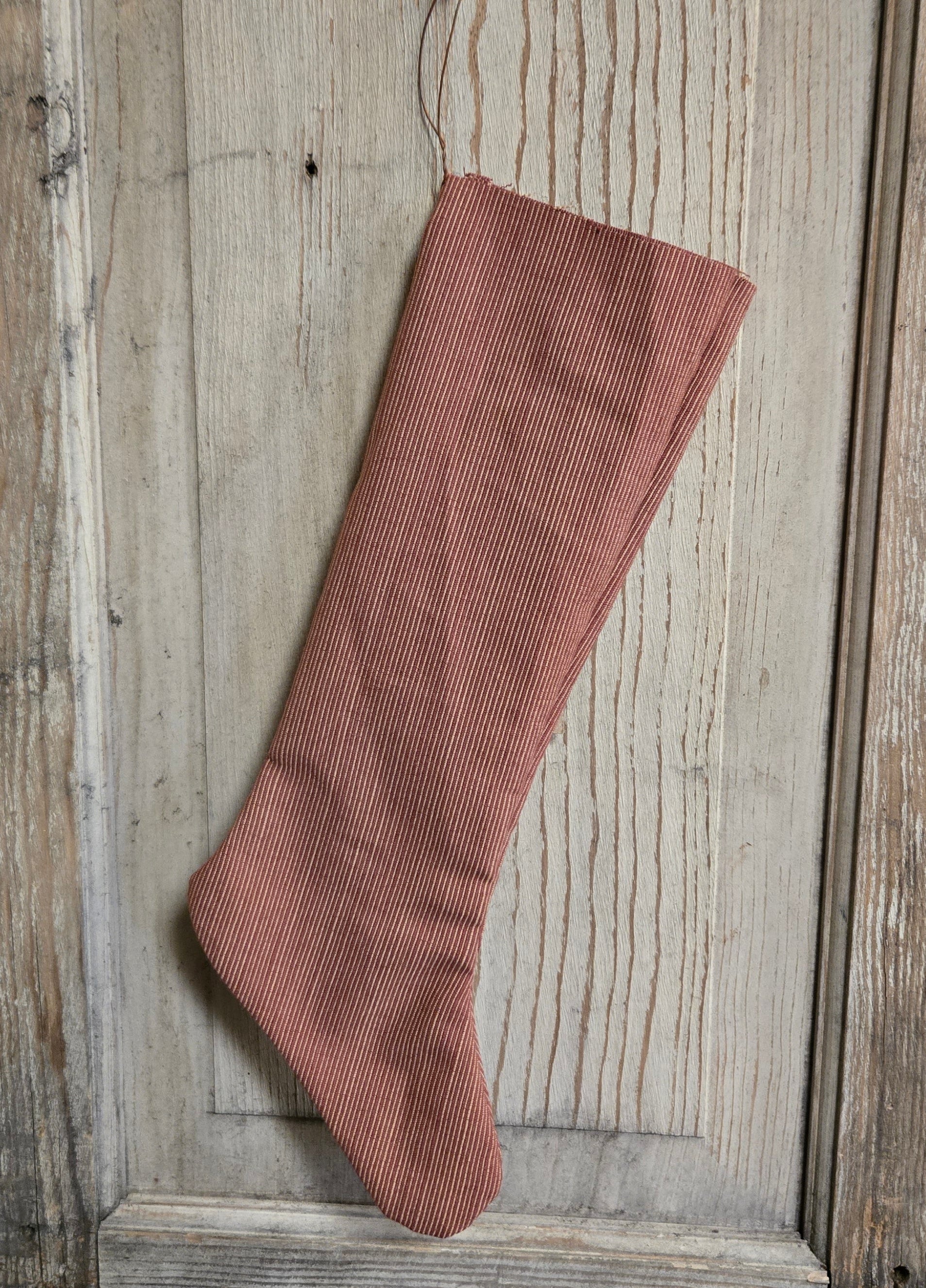 Red ribbed sock on a wooden surface