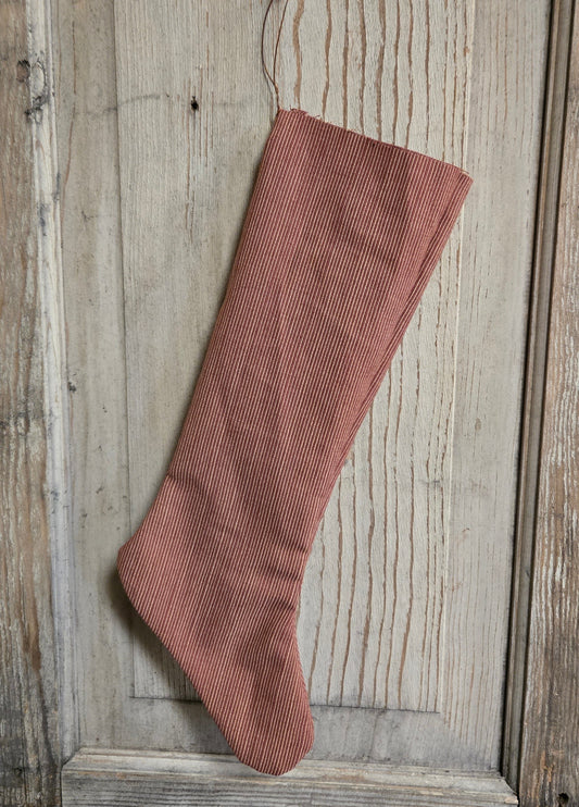 Red ribbed sock on a wooden surface