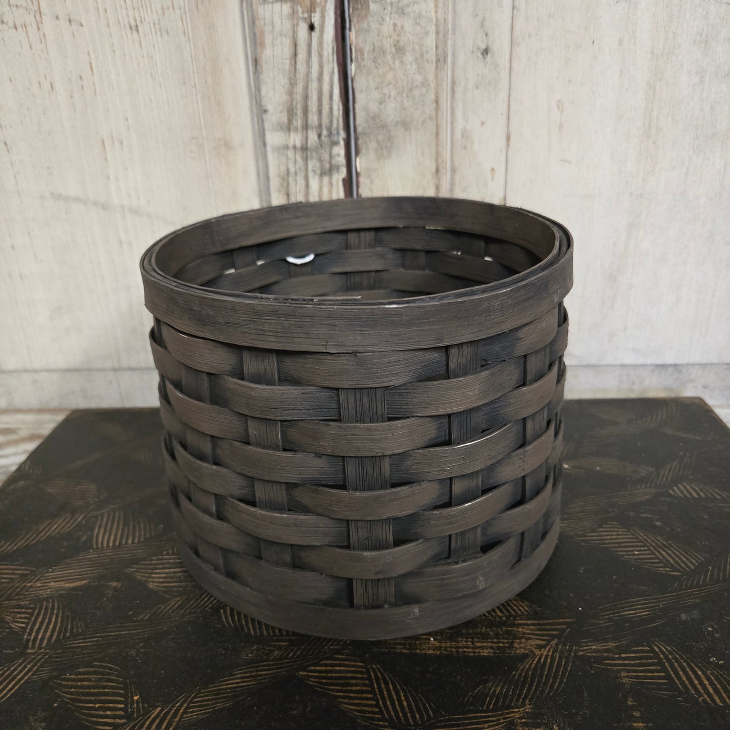 Primitive tree collar basket on a textured surface