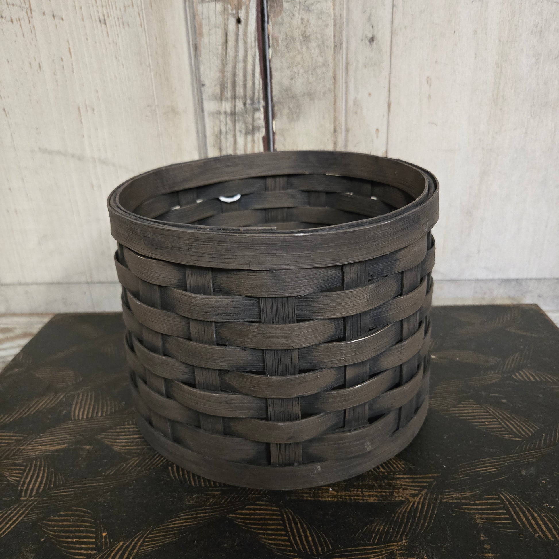 Primitive tree collar basket on a textured surface