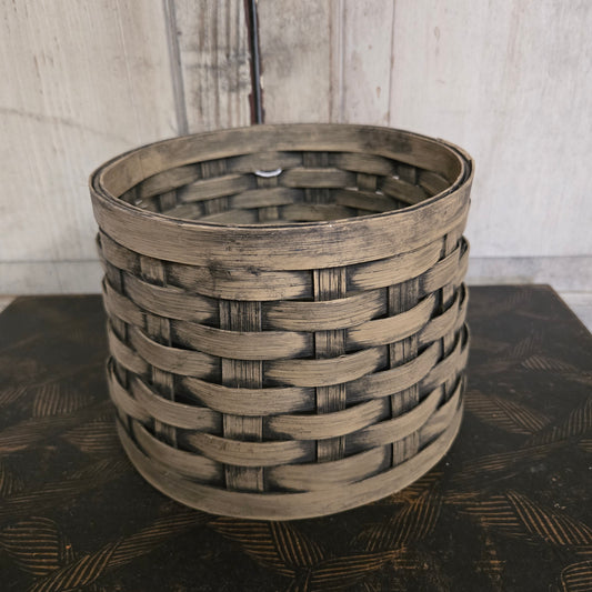 Woven basket against a textured wall