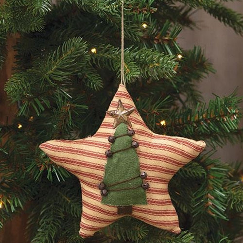 Star-shaped Christmas ornament with a green tree design hanging on a decorated tree.