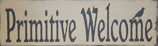 Wooden sign with 'Primitive Welcome' text on a wooden background