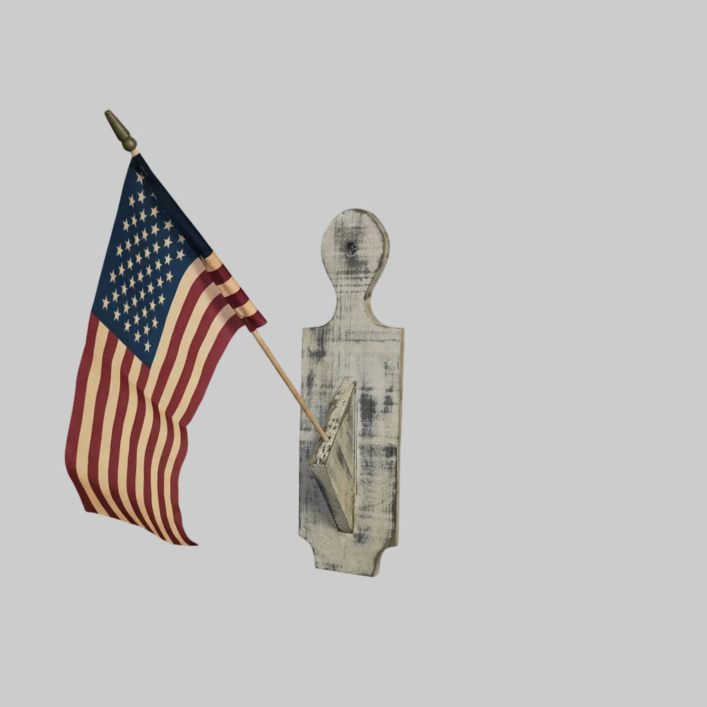 American flag on a wooden paddle against a light gray background