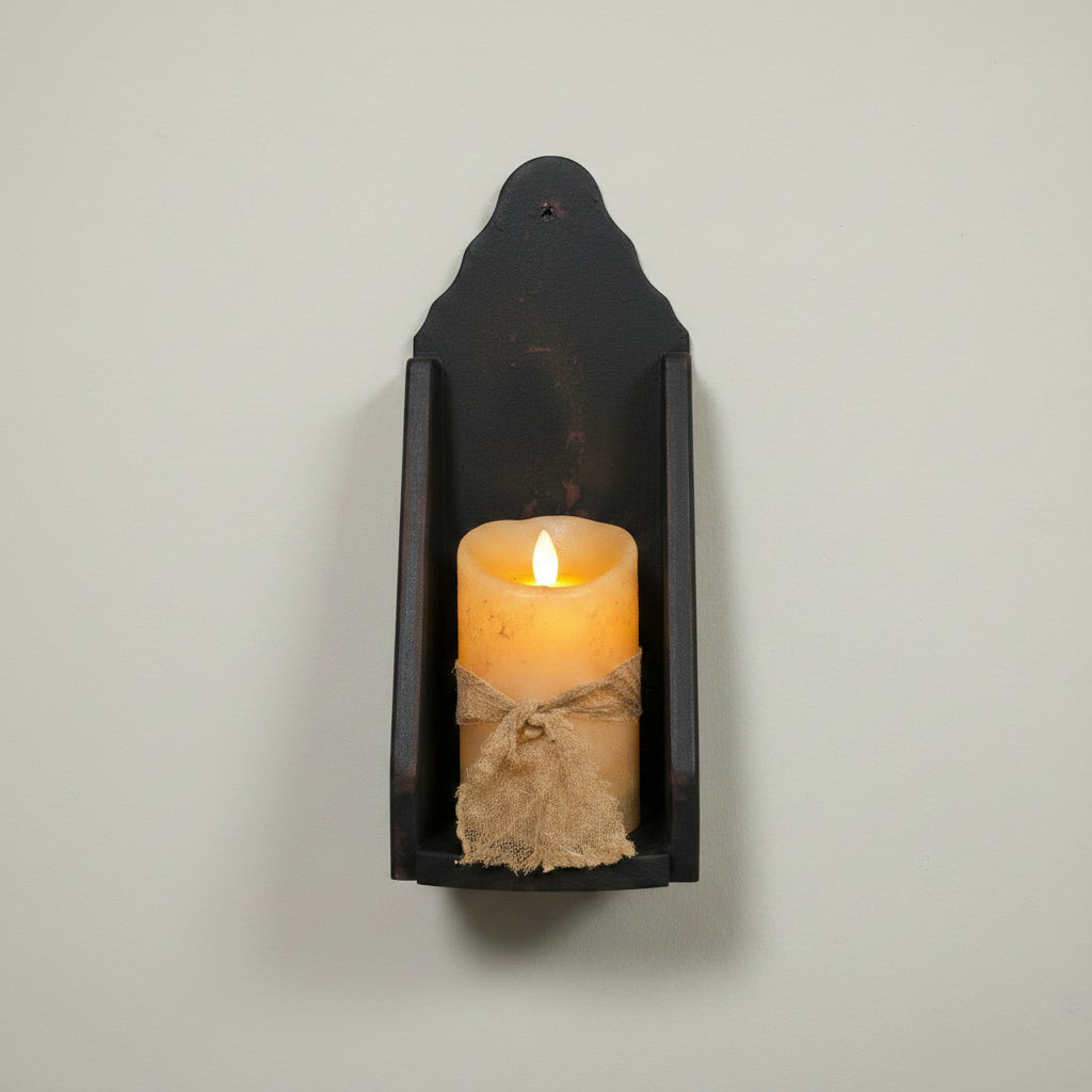 Decorative wall sconce with a candle on a wooden surface