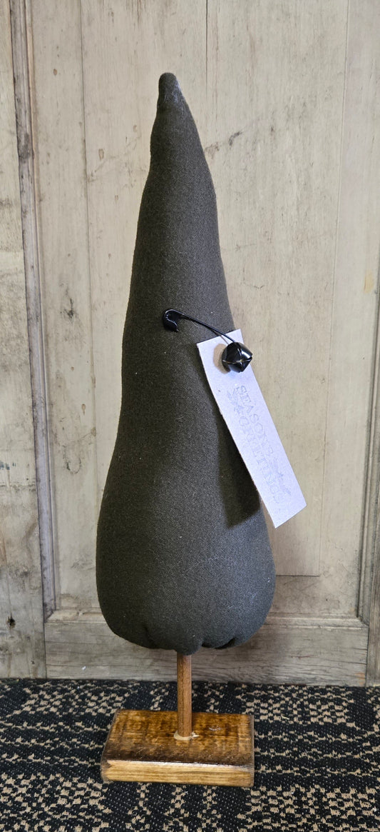 Textured gray cone-shaped object on a wooden stand with a tag against a wooden panel background.