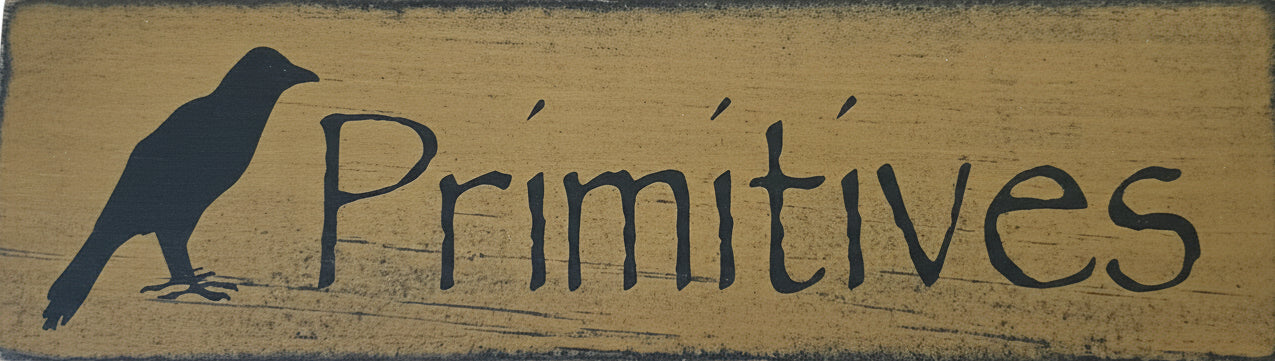 Wooden sign with 'Primitives' and a bird silhouette on a beige background