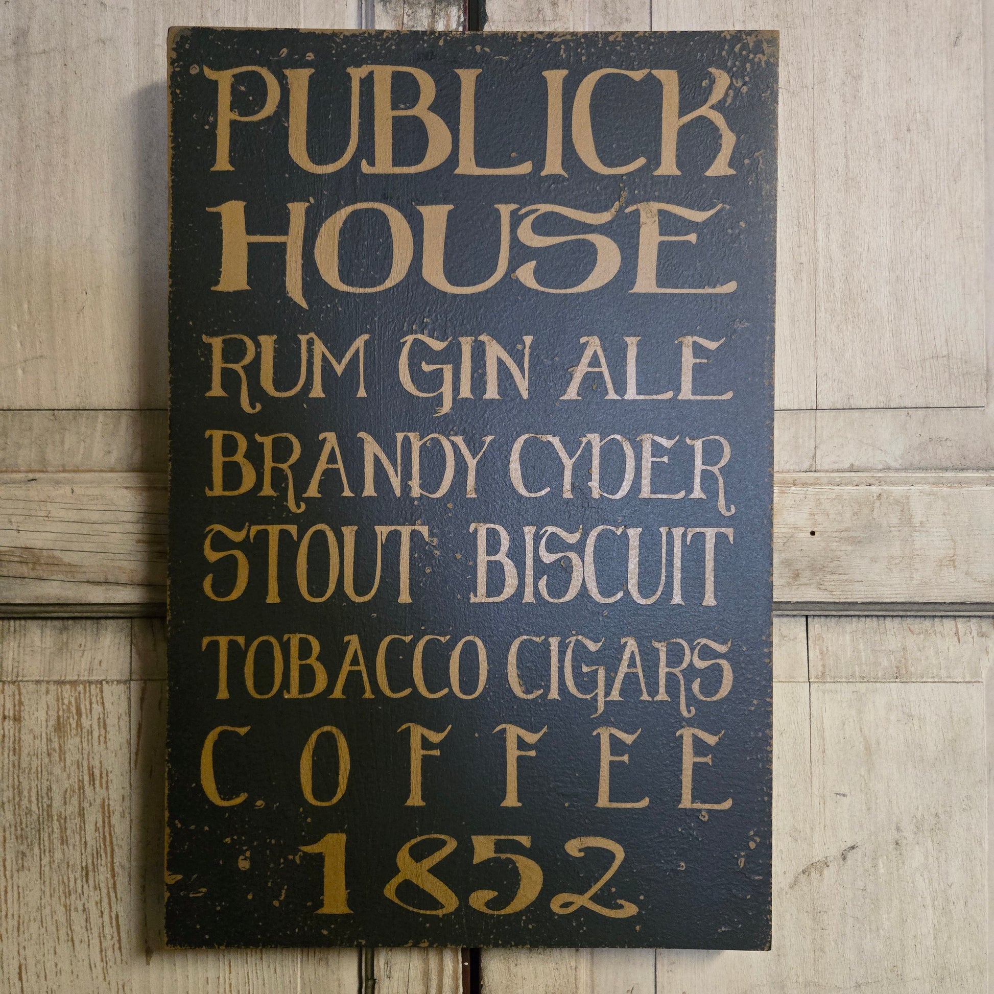 Wooden sign with text listing items and years on a wooden surface