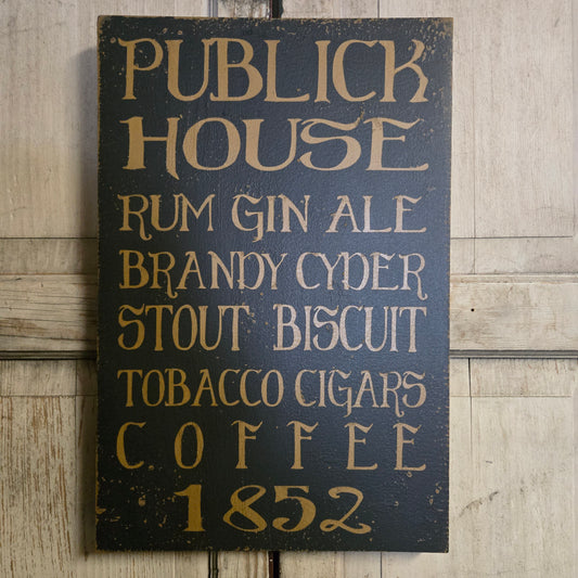 Wooden sign with text listing items and years on a wooden surface