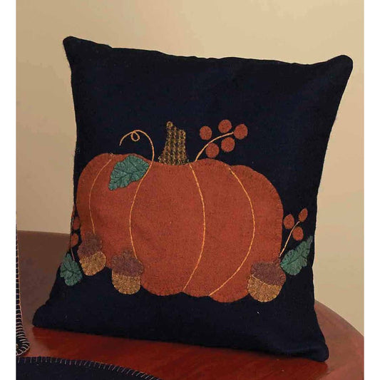 A square-shaped throw pillow with a decorative design featuring pumpkins, acorns, and autumn-themed leaves on a dark blue background.