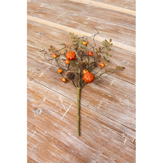 A decorative pumpkin and berry pick featuring artificial pumpkins and berries arranged on a wooden surface.