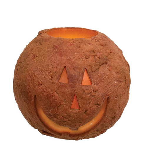 Pumpkin-shaped candle holder with a jack-o'-lantern face on a white background