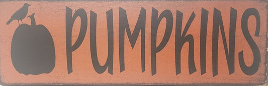Wooden sign with 'PUMPKINS' text and pumpkin silhouette on a white background