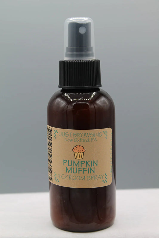 A 4oz bottle of Pumpkin Muffin room spray with a mist spray top. The label features the product name and an image of a cupcake.