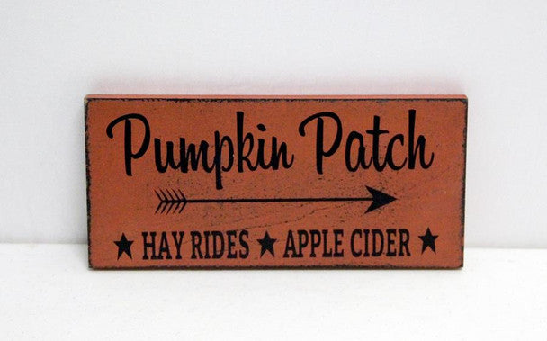 Wooden sign with 'Pumpkin Patch' text and arrow on a white background