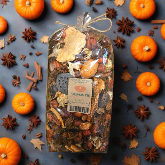 Packaged pumpkin pie spice mix with a label on a decorative background of green leaves.