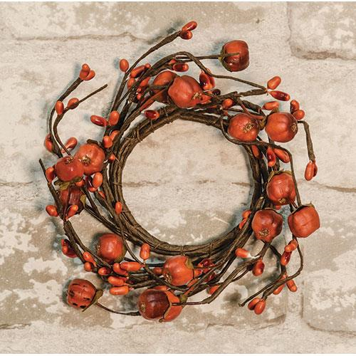 Pumpkin pod candle ring on white brick background