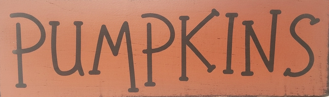 Wooden sign with 'PUMPKINS' text on a orange background