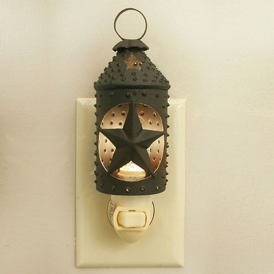 Night light made as a miniature Paul Revere style lantern with cut out star plugged into a wall outlet 