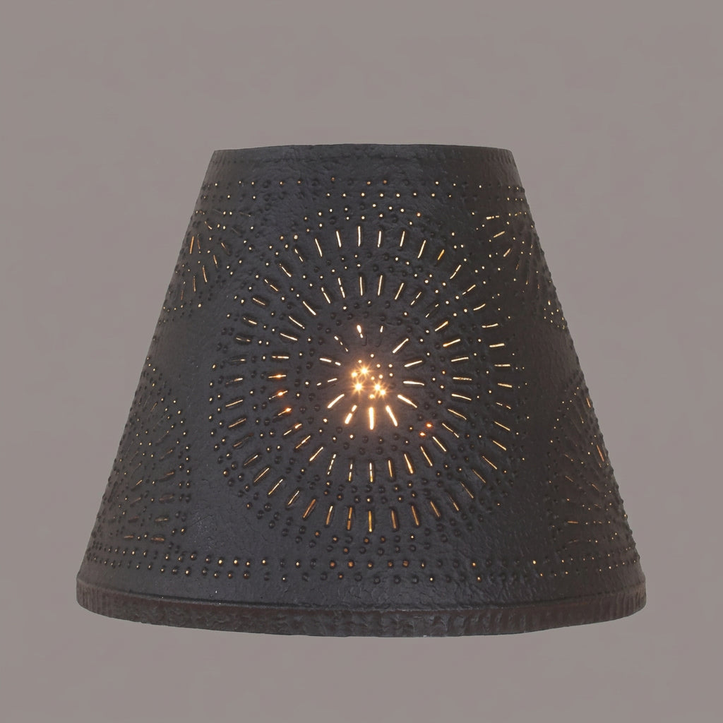 Black lampshade with decorative cut-out pattern on a white background