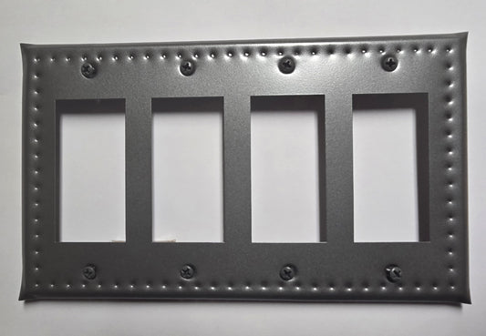 Decorative black metal switch plate with four blank panels on a white background