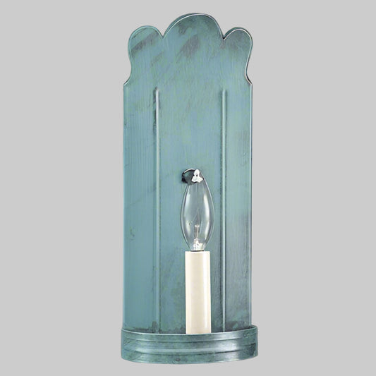 Decorative wall sconce with scalloped design on a gray background
