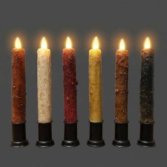 Six glowing Luminara moving flame taper candles in assorted rustic colors, displayed in black holders against a gray background.