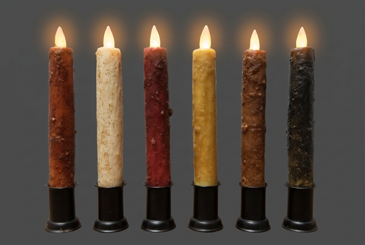 A realistic moving flame taper candle in various colors including burnt orange, ivory, burgundy, mustard, dark brown, and black, each with a white tip at the top.