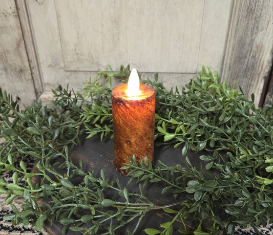 Realistic moving flame battery operated timer votive in brown.