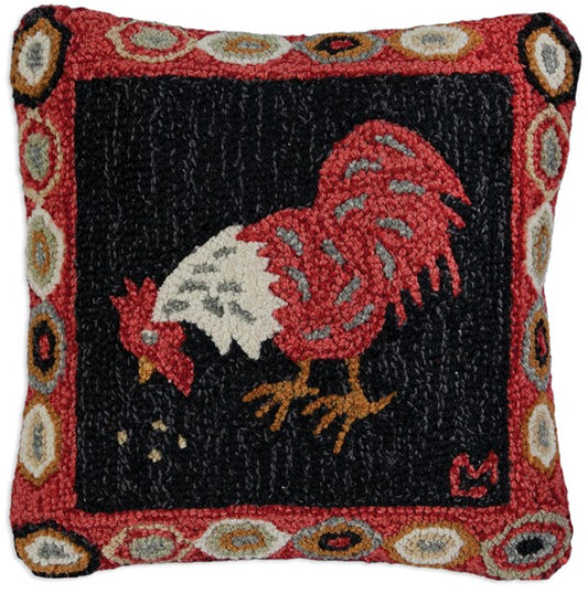 A square-shaped hooked wool pillow with a red rooster design and a velveteen backing, featuring a geometric pattern around the border.