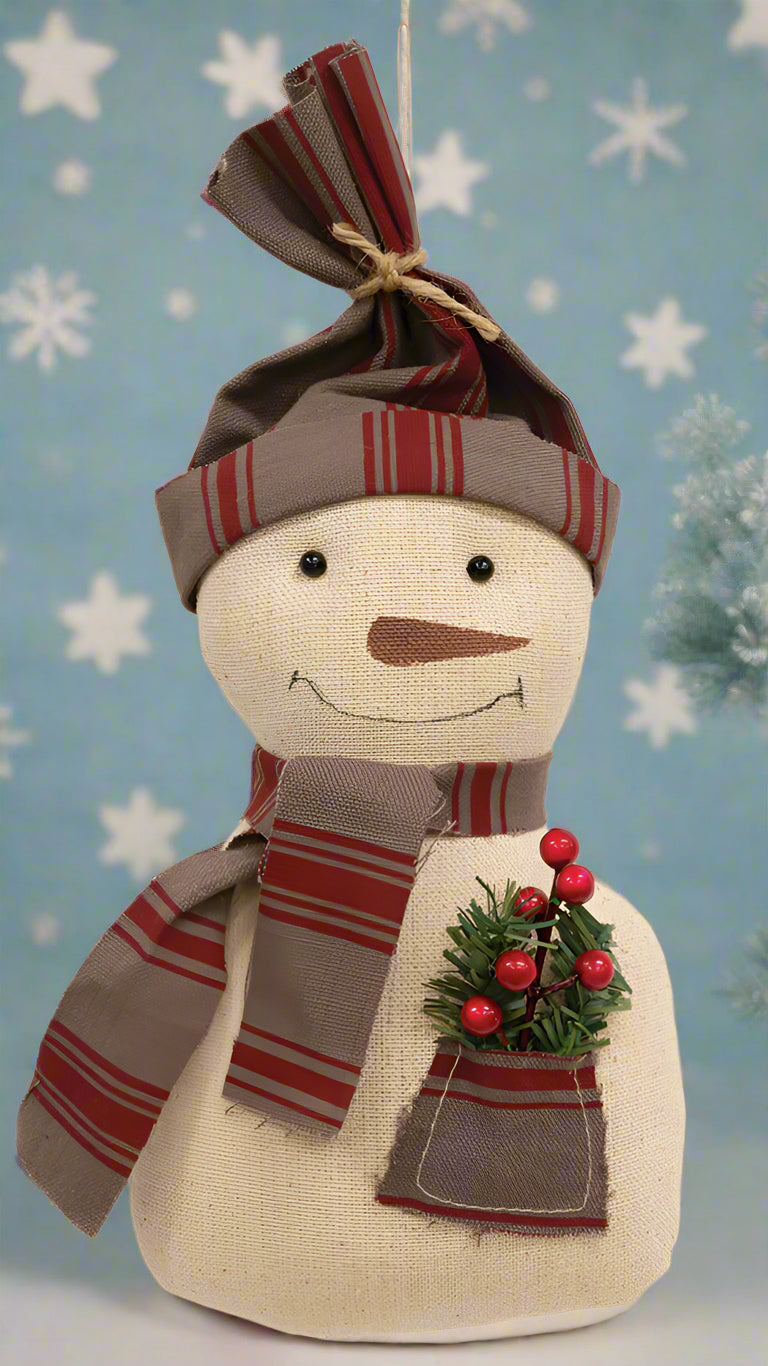 Primitive snowman doll with striped hat and scarf.