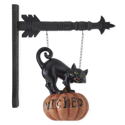 Decorative Halloween sign with a black cat on a pumpkin labeled 'Wicked'.