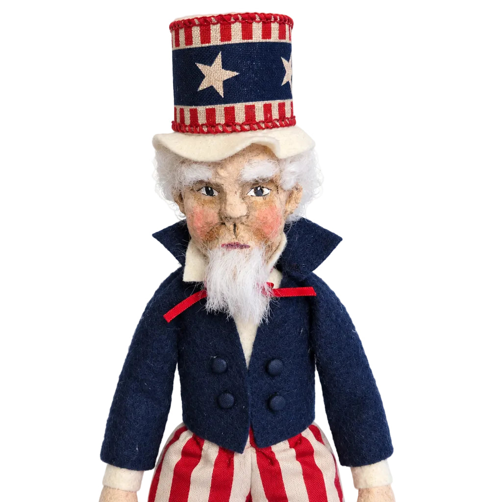 Decorative figure resembling a historical figure with a patriotic hat on a wooden surface.