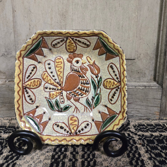 Octagonal redware plate with rooster and flower motif
