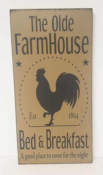 Wooden sign with rooster silhouette and text 'The Olde FarmHouse Bed & Breakfast' on a beige background