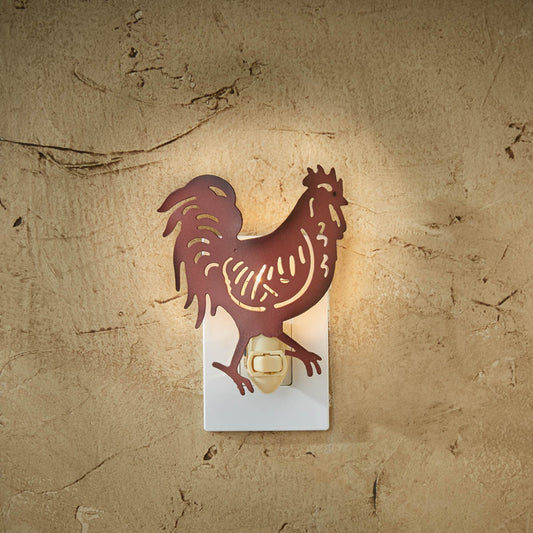 A silhouette of a rooster night light on a wall, casting a warm glow.