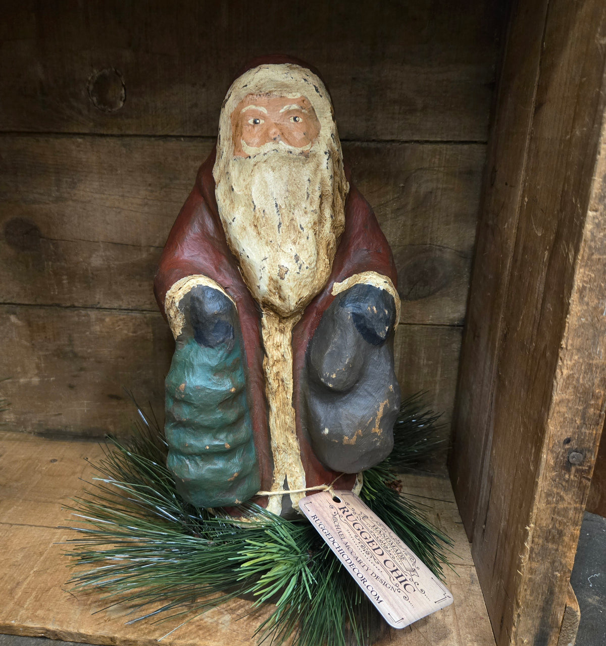 Wooden Santa Claus figurine with a tag on a wooden background