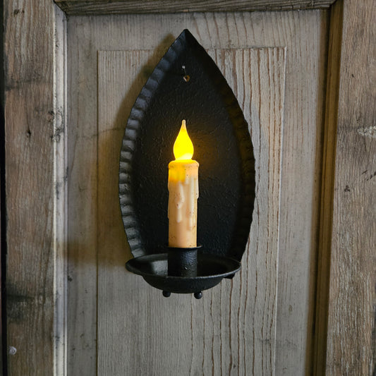 Decorative wall sconce with a candle-like light on a wooden background