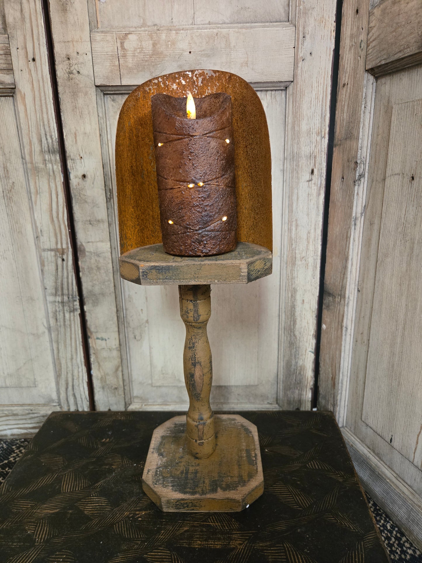 Wooden candle holder with a textured surface on a wooden background