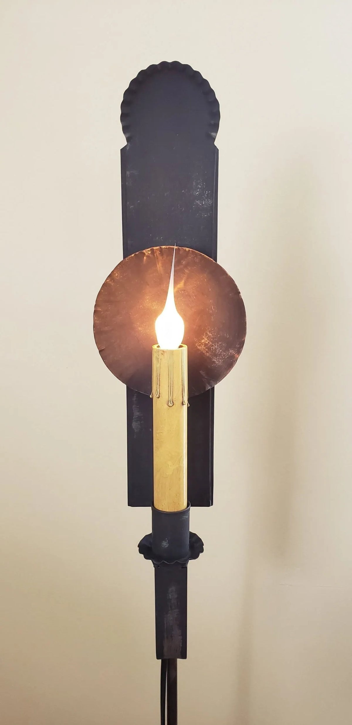 Close up view of tin lamp with one candle sleeve and silicone bulb.