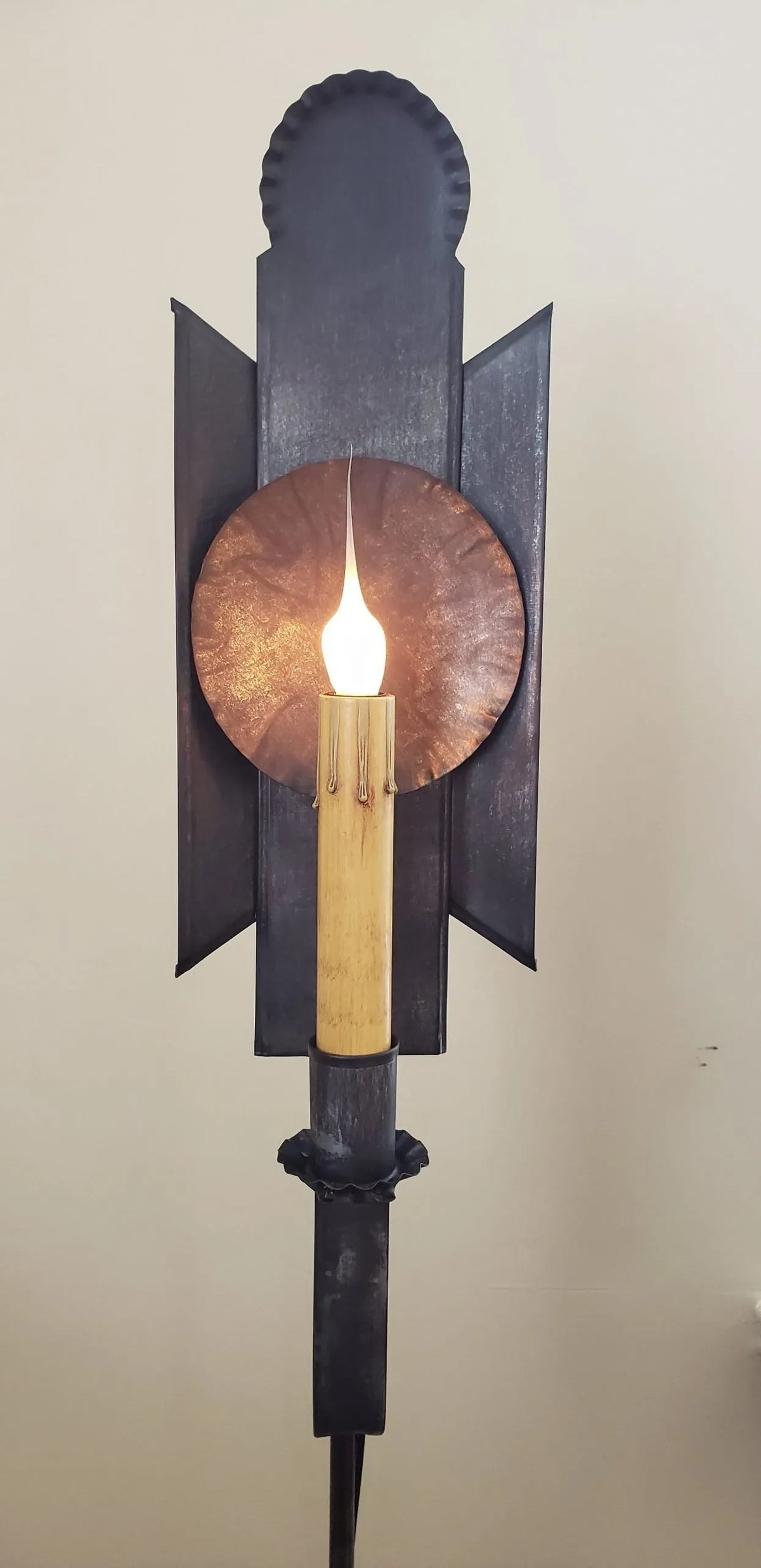 Close up view of tin lamp with one candle sleeve and silicone bulb.