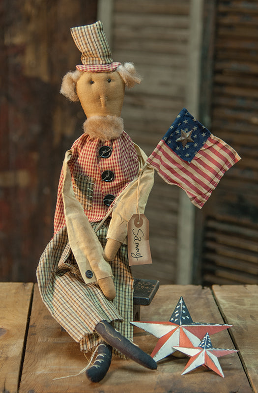 Vintage-style figurine with a checkered hat and American flag, sitting on a wooden surface.
