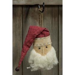 A plush Santa ornament with a red and white checkered hat and a brown nose, hanging from a fabric string.