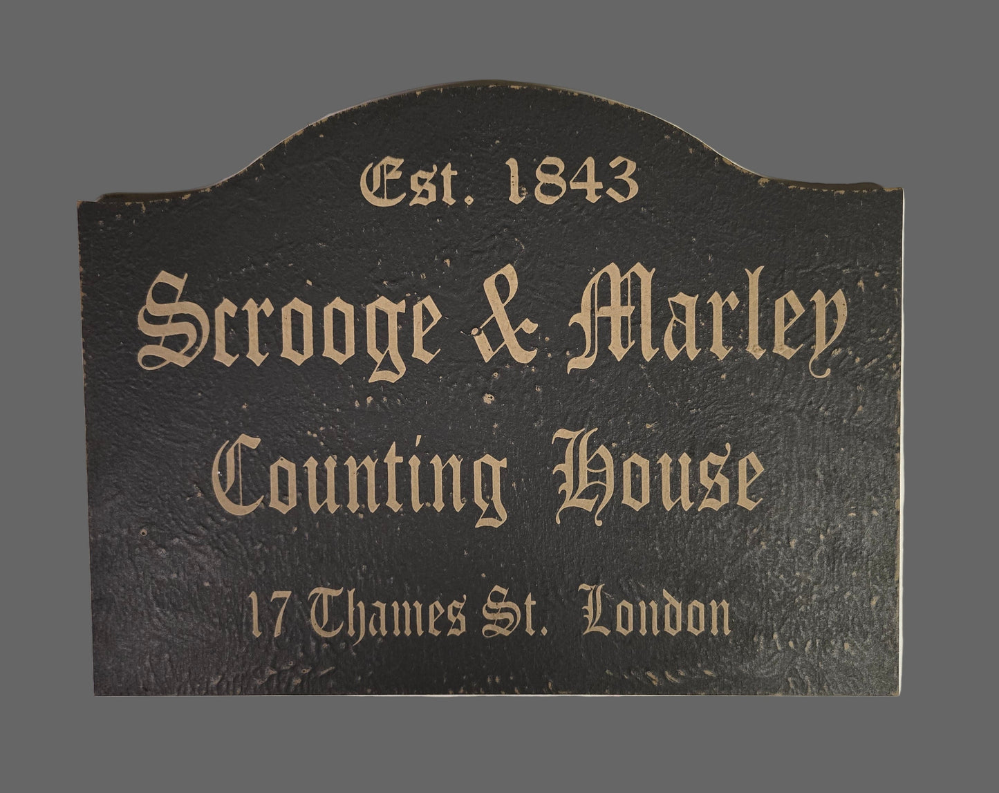 Decorative sign for 'Scrooge & Marley Counting House' with text on a dark background