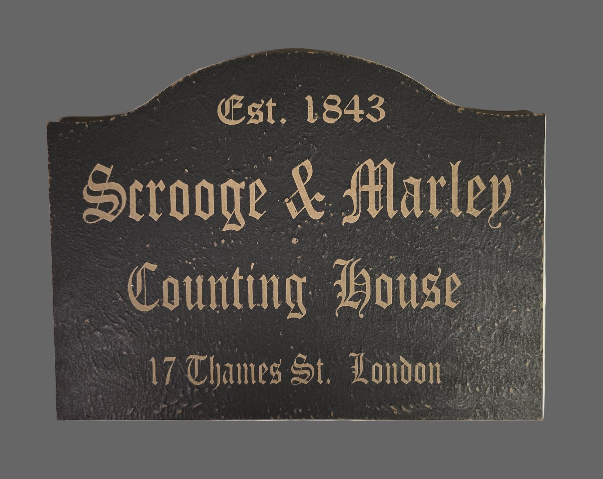 Decorative sign for 'Scrooge & Marley Counting House' with text on a dark background